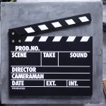 Movie clapboard or clapper at old table. Clapperboard and screenwriter or movie writer concept